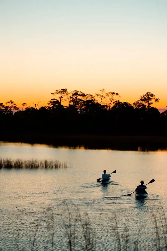 Kayaking a coastal dune lake at sunset